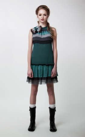Lifestyle. Fashion model lovely young girl posing in contemporary dress. Series of photosの写真素材