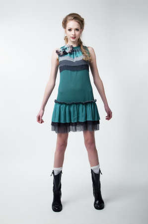 Pretty young fashion model female in contemporary dress posing in studio. Series of photosの写真素材