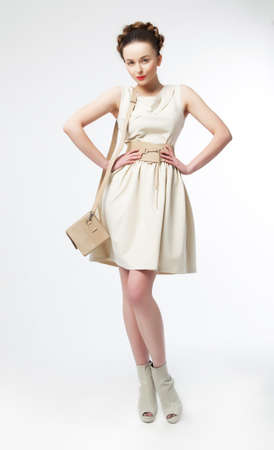 Fashionable beautiful young lady in white retro dressの写真素材
