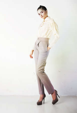 Perfect fashionable lady wearing white trousers and blouseの写真素材