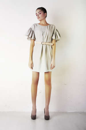 Sexy young woman wearing white short dress  Studio shot  Series of photosの写真素材