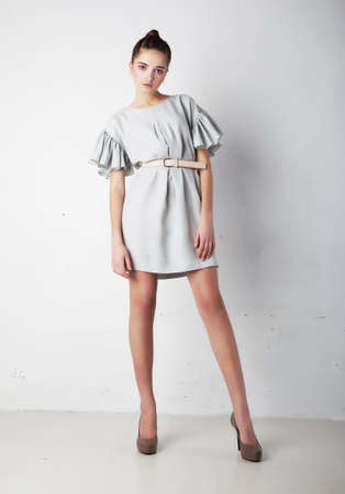 Fashion photo of young stylish woman posing in dress - series of photosの写真素材