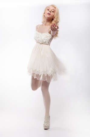 Romantic young pretty woman running in white dressの写真素材