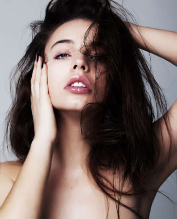 Young brunette woman hairstyle fashion model - studio shotの写真素材