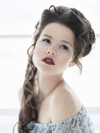 Close-up portrait of attractive young model girl with bright make-up and hairstyleの写真素材