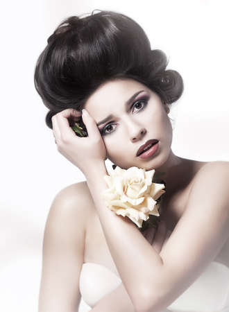 Beauty  Serene young pretty woman with flower の写真素材