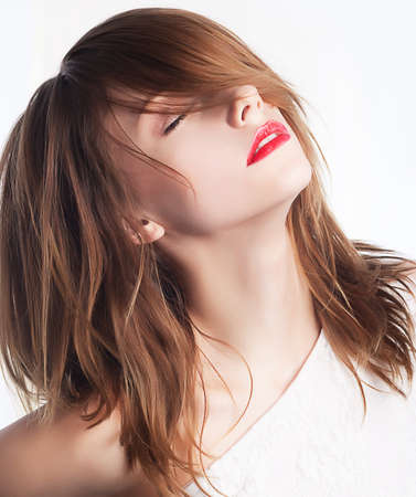 Beautiful face of young woman with clean skin and long hairs  Chic red lipsの写真素材