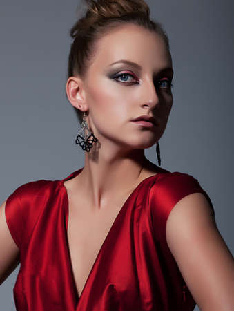 Portrait of attractive woman in red dress  Studio shotの写真素材