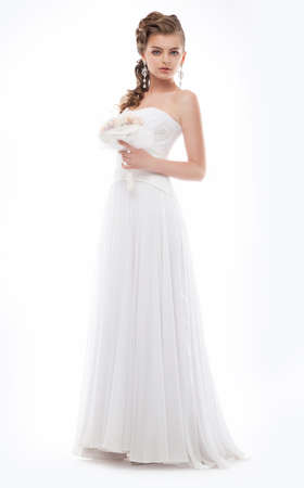 Beautiful bride dressed in white dress posing isolated  Studio shotの写真素材