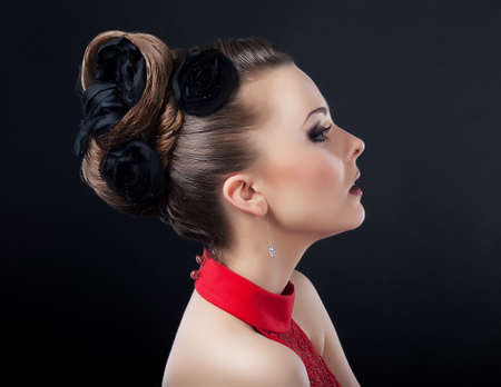 Beautiful young woman face with creative plait hairstyle lookingの写真素材