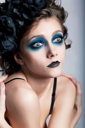 Girl with bright unusual conceptual make-up  painted face  closeup portraitの写真素材