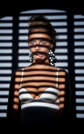 Silhouette of elegant fashion woman - striped windowの写真素材