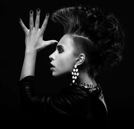 Strange stylish punk female saluting and gesturing, creative hairstyleの写真素材