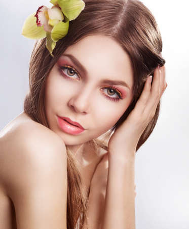 Beautiful fashion model woman with orchid flower  Sensualityの写真素材