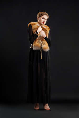 Fashion Woamn in Black dress and Fox Fur Mantle - Glamour Styleの写真素材