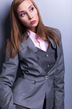 Elegance. Stylish Trendy Woman in Blue - Grey Costume posingの写真素材