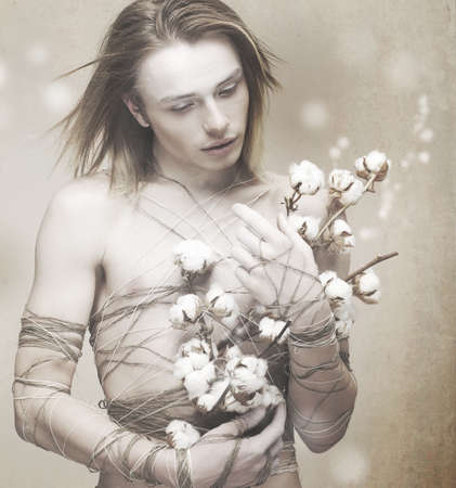 Blossom. Stylish Man with Flowers over Blurred Background. Delightの写真素材