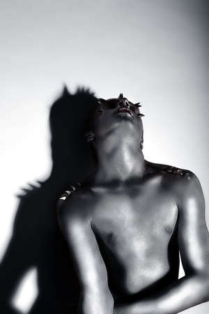 Expressive Emotions. Drama. Silver-plated Man posing. Creativityの写真素材