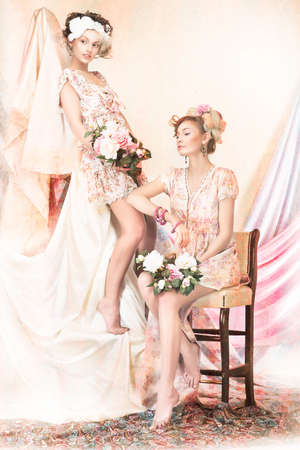 Sophistication. Old-Fashioned Concept. Two Pin Up Girls in Retro Dresses. Luxuryの写真素材