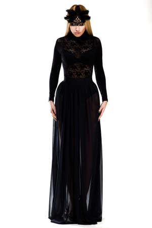 Charm. Gorgeous Woman in Long Black Dress and Cap. Haute Coutureの写真素材