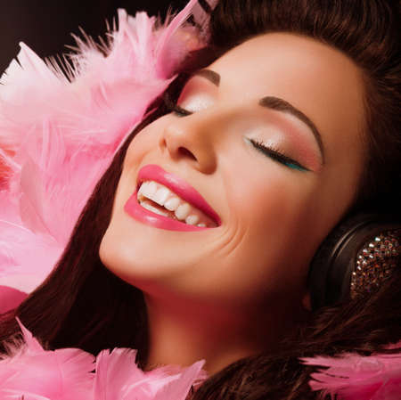 Inspiration  Fancy Cheerful and Happy Woman with pink Feathers smiling  Pleasureの写真素材