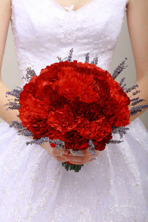 Donation. Compliment.Vernal Bouquet of Red Flowers in Woman's hands. Felicitationの写真素材