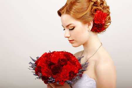 Mildness. Profile of Calm Woman with Red Bouquet of Flowers. Tranquility & Gentlenessの写真素材