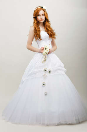Tenderness. Redhaired Exquisite Bride in White Bridal Dress. Wedding Fashion Collectionの写真素材