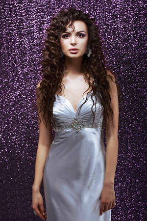 Sophistication  Glamor  Sensual Brunette with Waved Hairs and Silk Blue Dressの写真素材