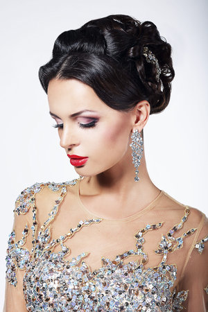 Formal Party. Gorgeous Fashion Model in Ceremonial Shiny Dress with Jewels