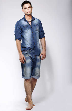 Full Length Portrait of Young Confident Barefoot Man in Blue Jeansの写真素材