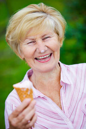  Contentment. Jubilant Ecstatic Old Woman Holding Ice-Cream and Laughingの写真素材