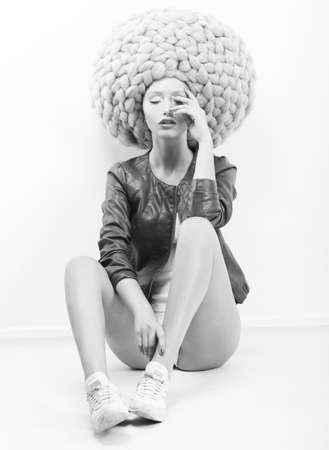 Art Modern. Futuristic Woman in Trendy Huge Lust Wig with Braidsの写真素材