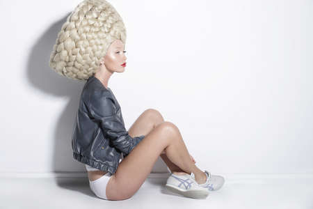 Fantasy & Inspiration. Woman in Unusual Wig with False Braided Hairの写真素材