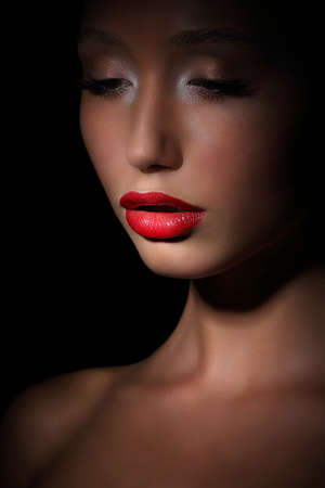 Accent. Highlight. Glamorous Exotic Asian Woman in Shadows. Evening Makeupの写真素材
