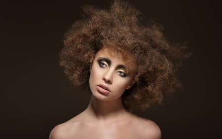 Stylization. Young Brunette with Curly Brown Hairsの写真素材
