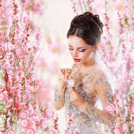 Woman with Perfume over Floral Backgroundの写真素材