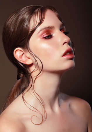 Fashion portrait of a young woman with bright makeup.の写真素材