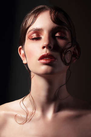 Closeup portrait of a beautiful lady with eyes closed.の写真素材