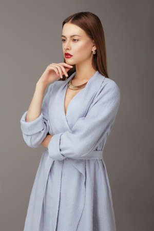Portrait of a young woman on a gray background.の写真素材