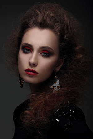 Fashion portrait of a woman with high hair and red lips. Photo shoot in the studio.の写真素材