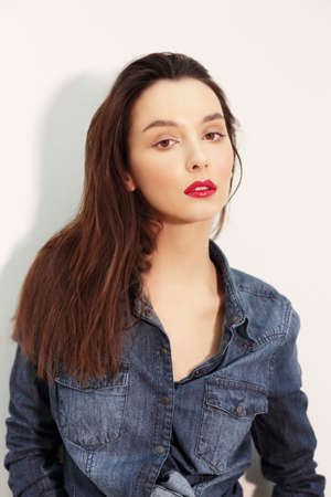 Young Caucasian female model. With bright lips and natural makeup.の写真素材