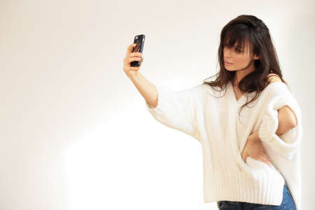 Girl taking selfie. Natural light.の写真素材