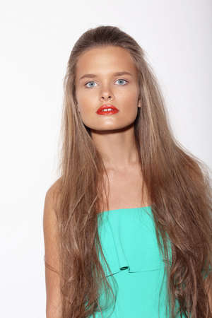Portrait of a beautiful teenage girl with long hair in studio.の写真素材