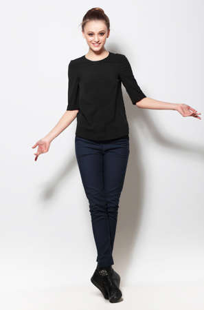 Young woman posing in full body and smiling. Clothing, fashion.の写真素材