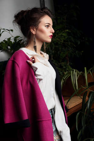 Woman. Young beautiful girl model in a crimson coat. Fashion, style.の写真素材