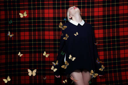 Young woman posing on a background of cellular blankets. Butterflies.の写真素材