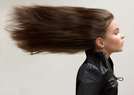 A girl with fluttering hair. Natural, healthy, creative.の写真素材