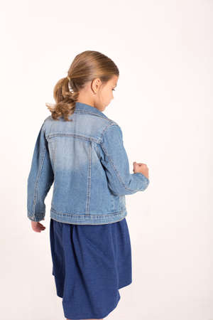 The girl in the denim jacket, stands back.の写真素材