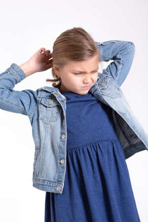 The girl removes a hairpin from her hair. It hurts, unpleasant. Get tangled in hair.の写真素材